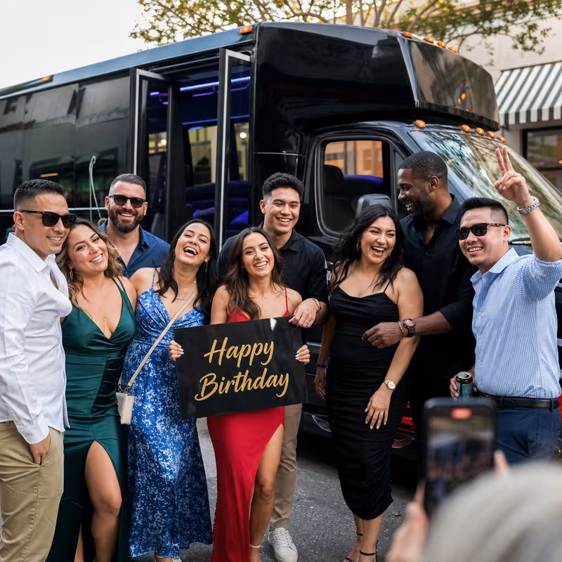Group boarding a white charter bus for Birthday Transportation transportation in Amarillo