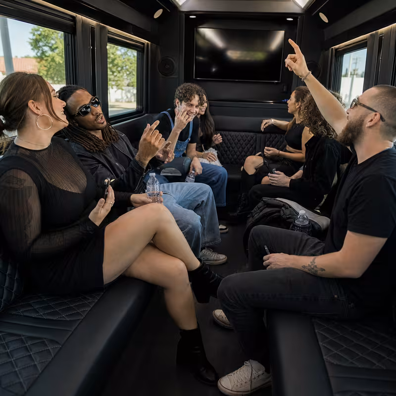 Group boarding a white charter bus for Concert Transportation transportation in Amarillo