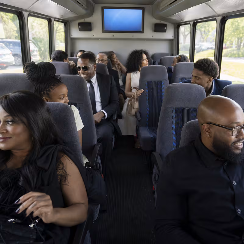 Group boarding a white charter bus for Private Event Transportation transportation in Amarillo