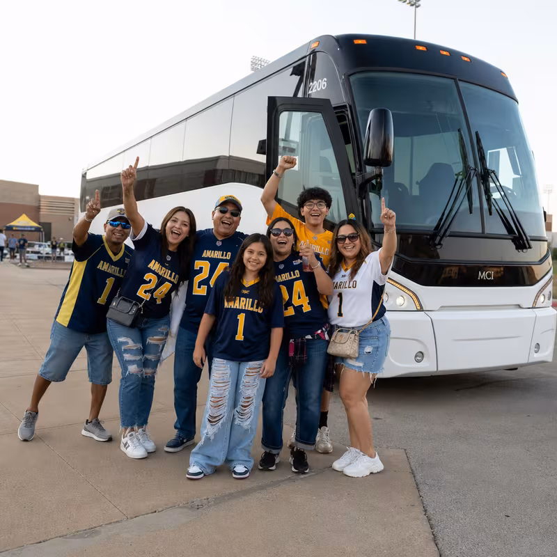 Passengers loading luggage while boarding an Amarillo group shuttle