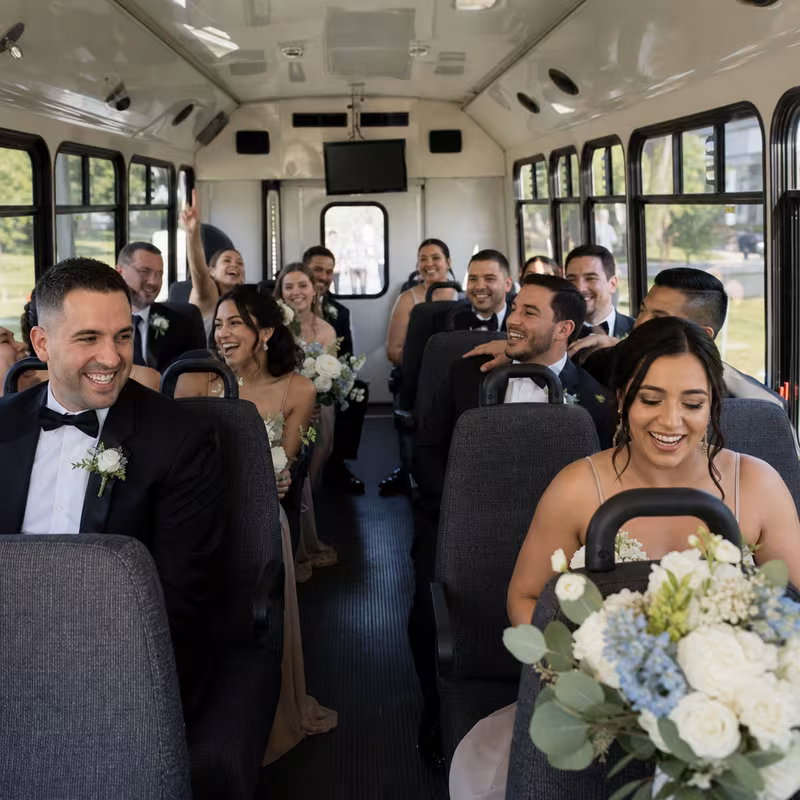 Group boarding a white charter bus for Wedding Transportation transportation in Amarillo